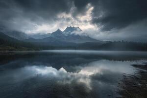 Mountain Reflection on Calm Lake Under Cloudy Sky with Forest photo