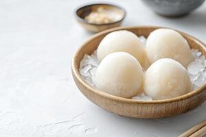 Serving Mochi Ice Cream Balls in Wooden Bowl with Crushed Ice photo