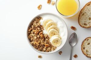 Enjoying a Healthy Breakfast Bowl with Yogurt, Granola, Banana and Juice photo