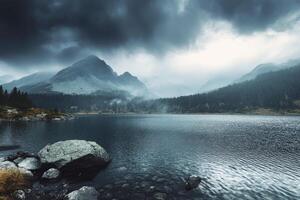 Moody Mountain Lake Landscape Under Overcast Sky with Rocks Foreground photo