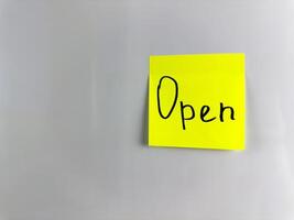 Sticky note with the inscription saying that it is open photo