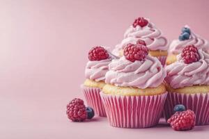 Cupcakes with raspberry frosting on pink background photo