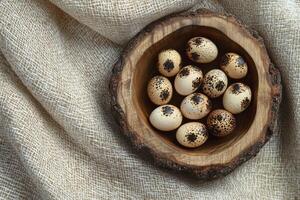 Quail Eggs in Wooden Bowl on Linen Fabric Rustic Composition photo