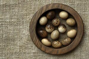 Quail Eggs in Rustic Wooden Bowl on Burlap Background Still Life photo
