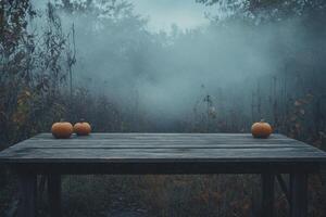 Pumpkins on Rustic Table in Foggy Autumn Forest Spooky Halloween Scene photo