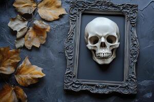 Skull in Antique Frame with Autumn Leaves on Dark Textured Background photo