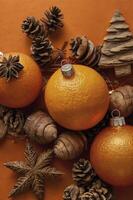 Festive Christmas Oranges and Pine Cones Still Life Arrangement on Orange photo