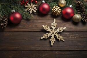 Arranging Christmas Ornaments and Decorations on Rustic Wooden Surface for Festive Mood photo