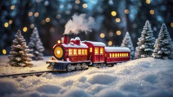 Toy Train Steam Engine on Snowy Track with Christmas Tree Backdrop photo