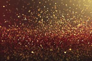Falling Golden Glitter and Sparkles with Dark Red Tones for Backgrounds photo