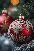 Red Christmas Ornaments with Silver Decorations Hanging on a Fir Tree photo