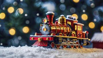 Toy Christmas Train in Snowy Scene with Christmas Tree Lights photo