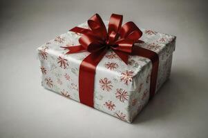 Wrapped Present with Red Ribbon and Snowflake Design for Holiday Celebration photo