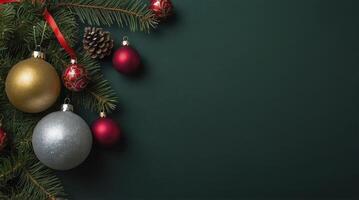 Christmas Ornaments on Evergreen Branches with a Red Ribbon on Dark Background photo