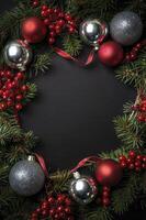 Christmas Decoration Frame with Ornaments and Berries on Dark Background photo