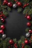 Christmas Festive Decoration with Pine Branches and Ornaments on Black Background photo