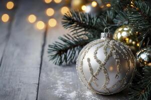 Christmas Ornament on Wooden Surface with Pine and Bokeh Lights Backdrop photo