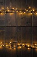 String Lights on Rustic Wooden Planks Creating a Warm Festive Ambience photo