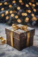 Gift Box with Gold Ribbon in Snow Under Festive Christmas Lights photo