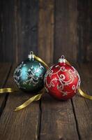 Festive Christmas Ornaments on Rustic Wood Surface with Gold Ribbon photo