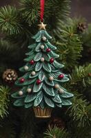 Hanging Christmas Tree Ornament on Green Pine Branches with Gold Star photo