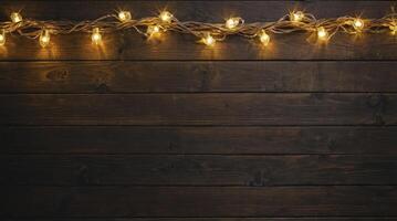 Glowing String Lights on Rustic Dark Wood Plank Background Texture photo