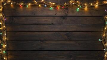 Dark Wood Background with Festive Christmas Lights Bordering the Top and Sides photo