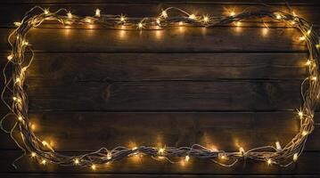 Wooden Background with Sparkling Fairy Lights Frame for Christmas Holiday photo
