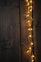 String Lights Decorating Dark Wood Surface Creating a Warm Atmosphere photo