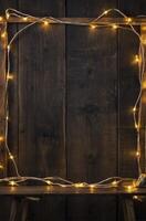 Rustic Wood Background Framed with Warm Fairy Lights Holiday Decoration photo