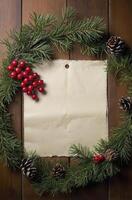 Pine Branch Wreath with Blank Paper and Red Berries on Wood photo
