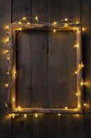 Rustic Wooden Frame with String Lights on Dark Wood Background photo