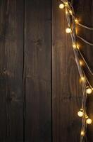Glowing String Lights on Dark Wood Background for Christmas or Holiday photo