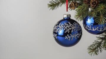 Hanging Christmas Ornaments on Pine Branch with Pine Cones Closeup photo