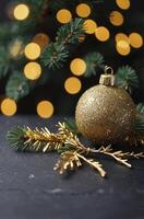 Festive Glittering Gold Christmas Ornament with Tree Branch and Bokeh Lights photo