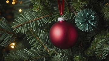 Hanging Christmas Ornaments on Pine Tree with Lights and Festive Decoration photo