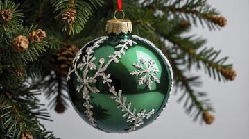 Hanging Christmas Ornament on Fir Tree with Snowflakes Decoration photo