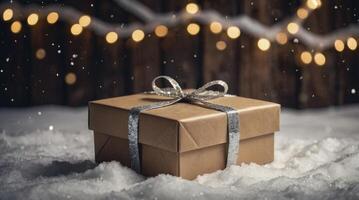 Present with Silver Ribbon Sitting on Snow with Bokeh Background photo