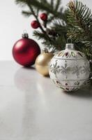 Festive Christmas Ornaments with Pine Branch on Marble Surface Still Life photo