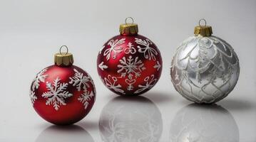 Festive Christmas Ornaments with Snowflake Designs on Reflective Surface photo
