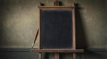 Blank Chalkboard on Easel with Wooden Pencil Against a Textured Wall photo