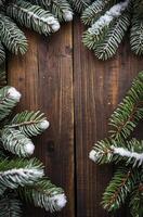 Snowy Fir Branches Frame Rustic Wood Background for Winter Season photo