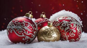 Decorated Christmas Ornaments in Snow on Red Background for Holiday Season photo