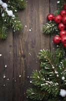 Festive Christmas Decoration with Fir Branches and Red Balls on Wood photo