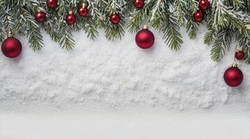 Festive Christmas Tree Branch with Snow and Red Ornaments photo