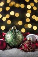 Ornate Christmas Ornaments on Fluffy White Surface with Bokeh Background photo