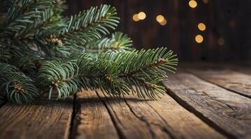 Fir Branch on Rustic Wood Surface with Blurred Lights Background photo