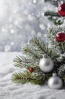 Festive Christmas Tree Branch Decorated with Shiny Ornaments in Winter Snow photo
