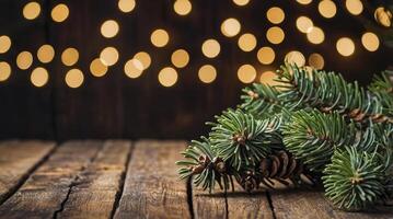 Fir Branch and Pine Cones on Rustic Wood with Bokeh Lights photo