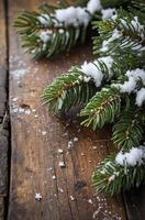 Snow Covered Fir Tree Branch on Rustic Wood for Winter Holiday photo